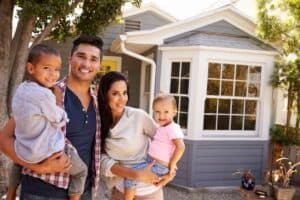 Family posing outside their home.
