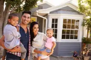Family posing outside their home.
