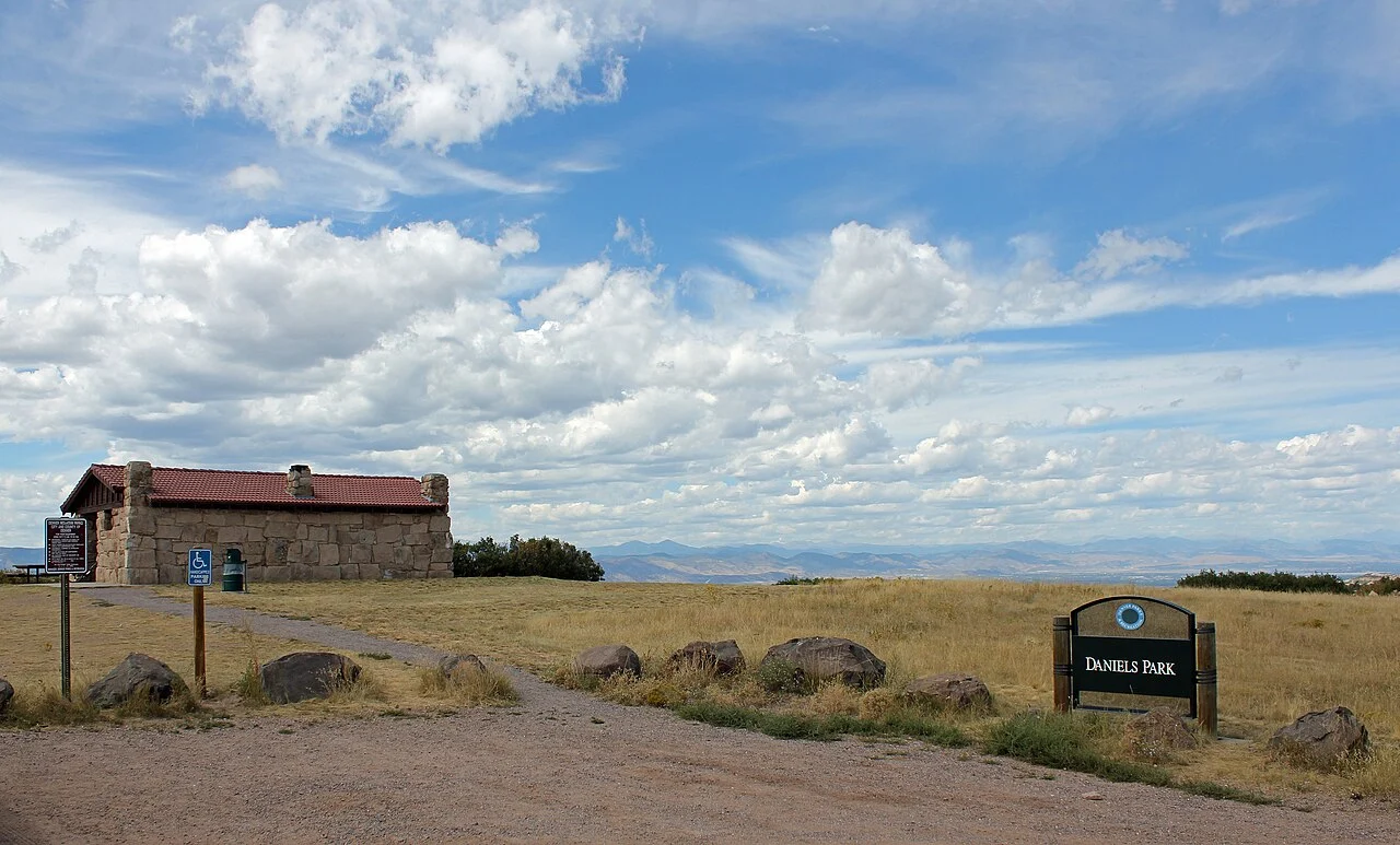 A historic stone building and open meadow at Daniels Park in Douglas County, Colorado.