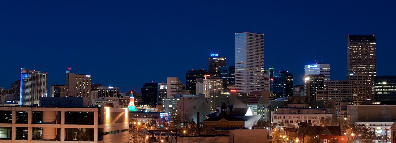 Downtown Denver's skyline illuminated at blue hour.