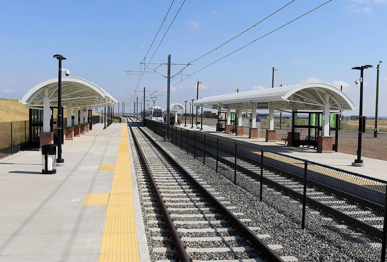 Light-rail tracks and platforms at Lone Tree City Center station in Colorado.