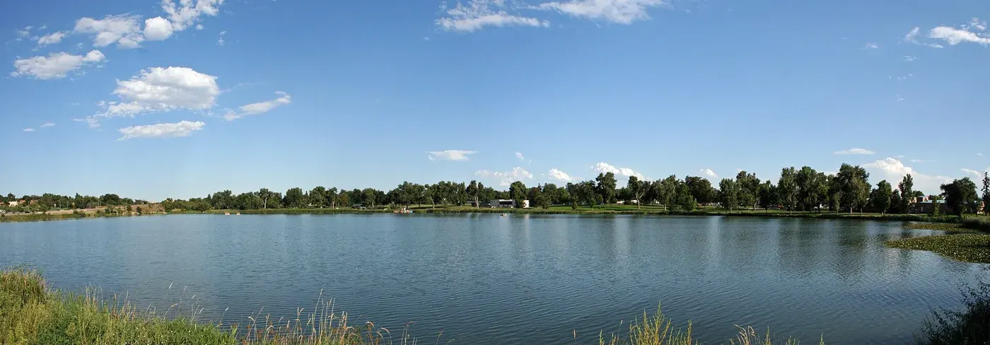 Blue water and tree-lined shores at Berkeley Lake Park in Denver