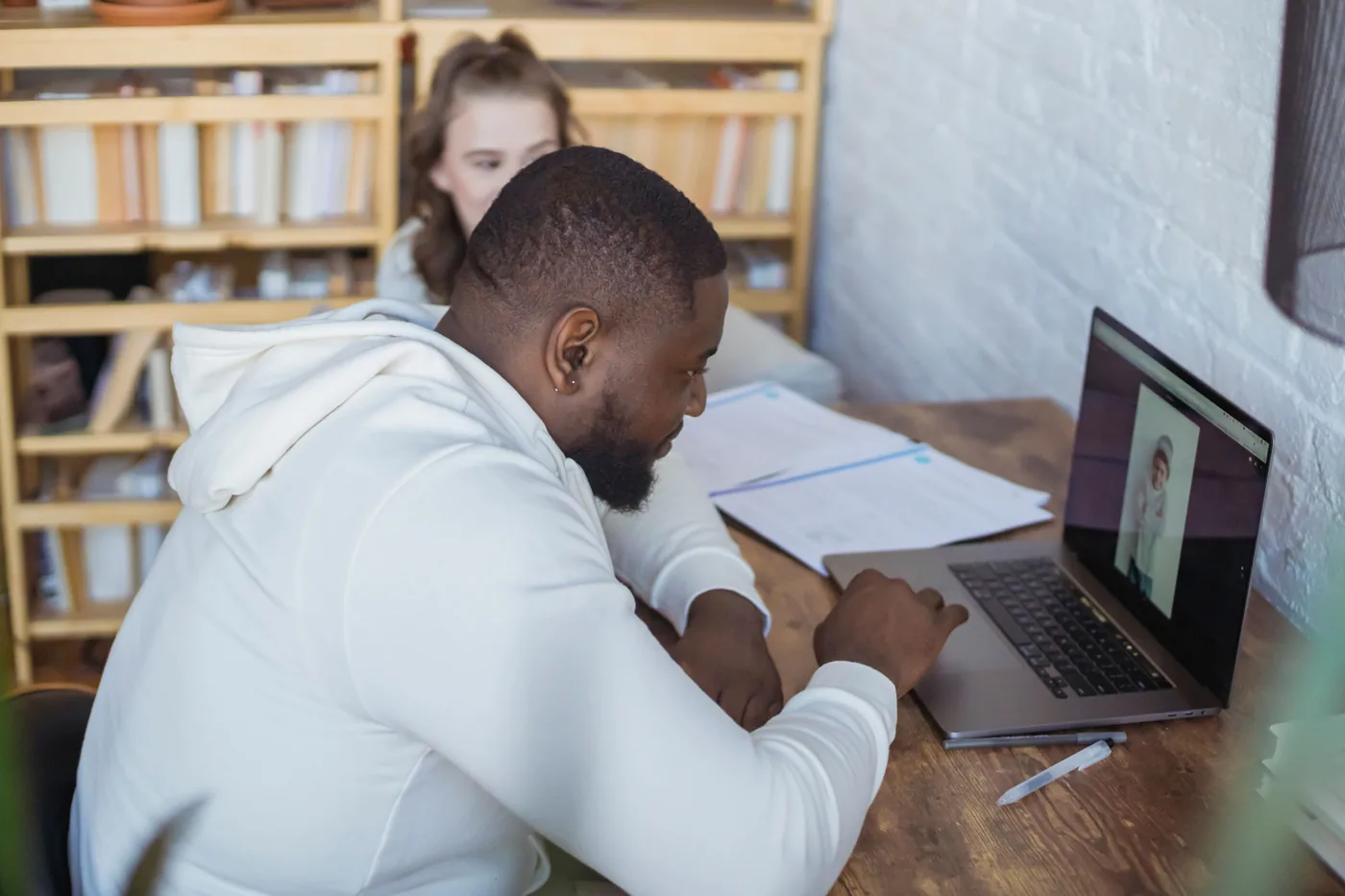 Two colleagues reviewing financial documents at a desk.