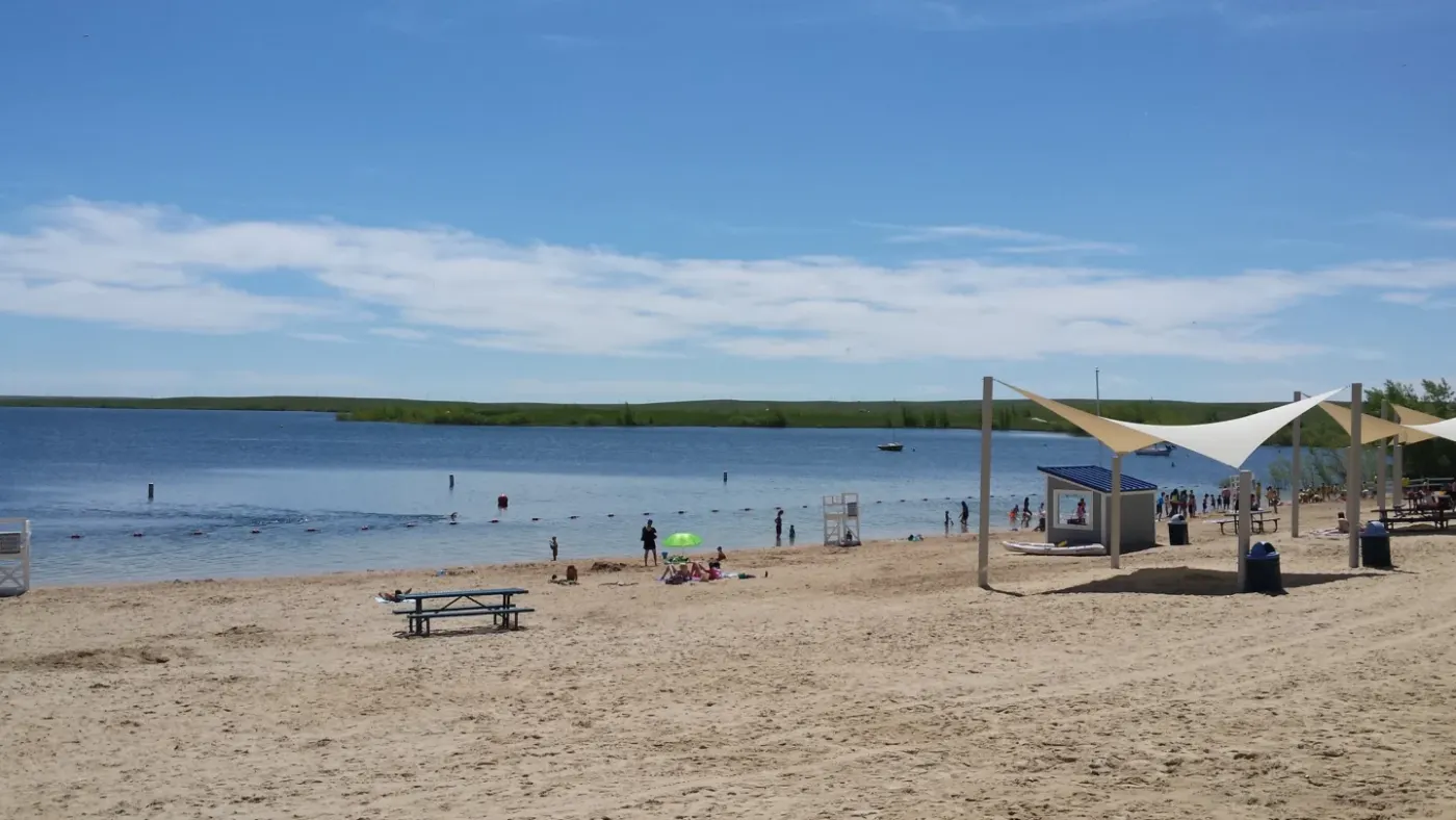 Aurora Reservoir beach and blue water with green shoreline in Aurora, Colorado