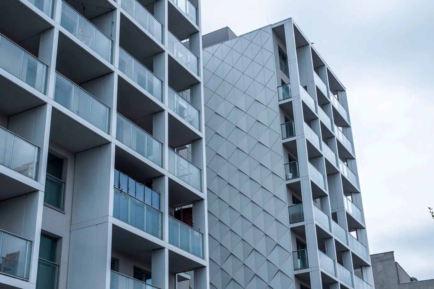modern multifamily apartment building with balconies and glass windows