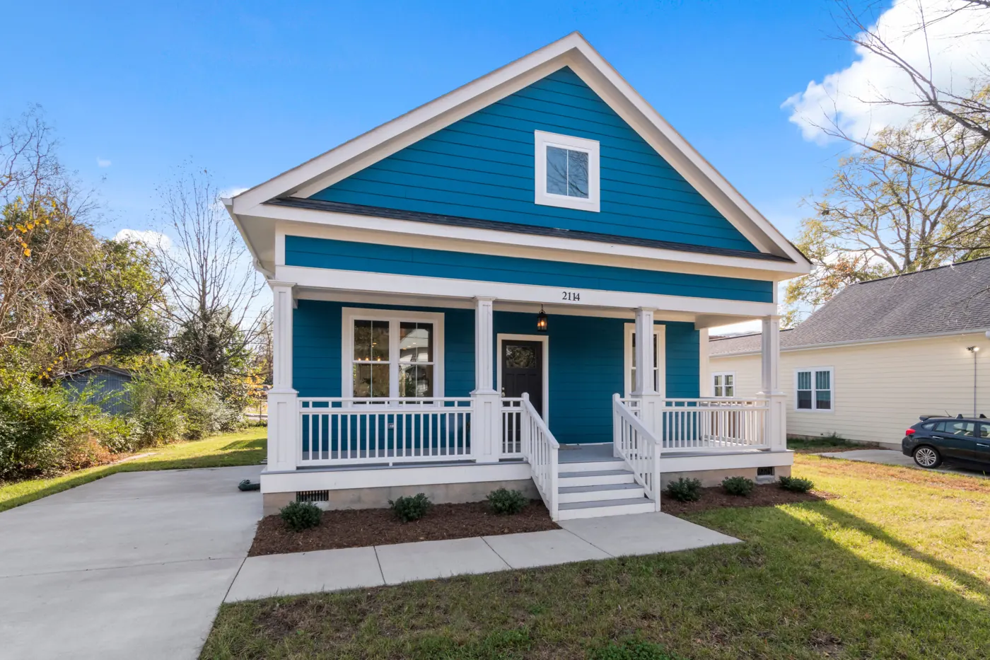 Blue bungalow with a white front porch.