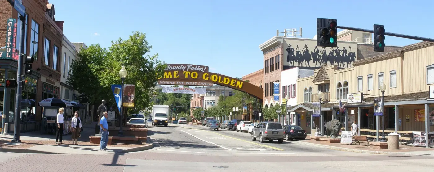 Washington Avenue storefronts and the welcome arch in downtown Golden, Colorado