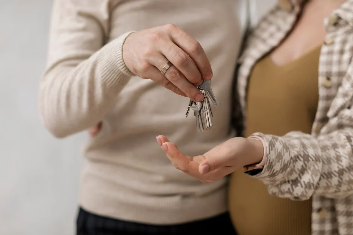 Couple receiving keys to a new home